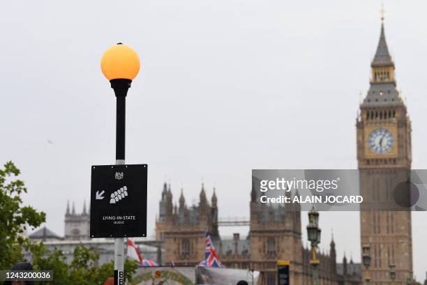 Sign directs members of the public to the queue for Westminster Hall, where Queen Elizabeth II will Lie In State, opposite the Palace of Westminster,...