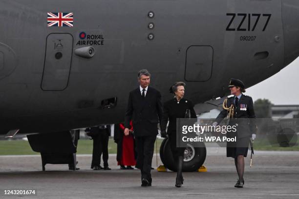 Britain's Princess Anne, Princess Royal, and Vice Admiral Timothy Laurence are greeted by Station Commander Group Captain McPhaden having disembarked...