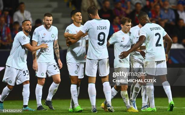 Inter Milan's Dutch midfielder Denzel Dumfries celebrates scoring his team's second goal with teammates during the UEFA Champions League Group C...