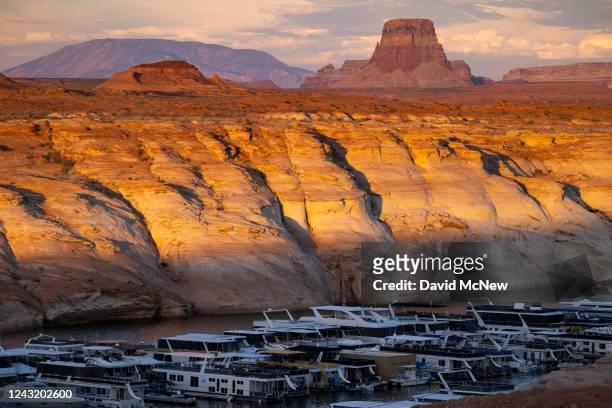 Boats descend lower into a desert canyon at Antelope Point Marina, requiring construction of alternative boat ramps, as Lake Powell continues to...