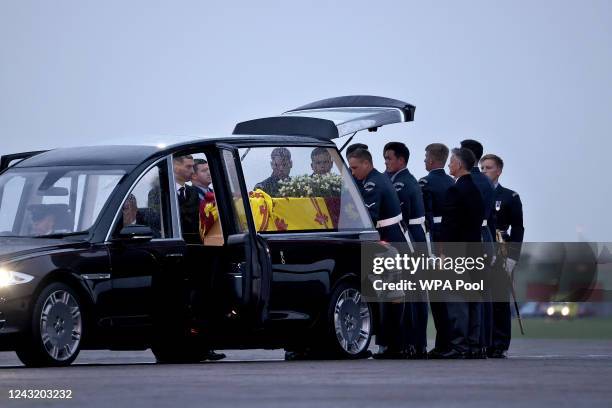 Pallbearers from the Queen's Colour Squadron carry the coffin of Queen Elizabeth II to the Royal Hearse having removed it from the C-17 at the Royal...