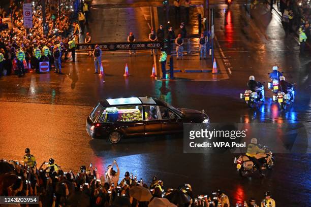 Seen from the top of the Wellington Arch, the coffin of Queen Elizabeth II is taken in a royal hearse to Buckingham Palace to lie at rest overnight...