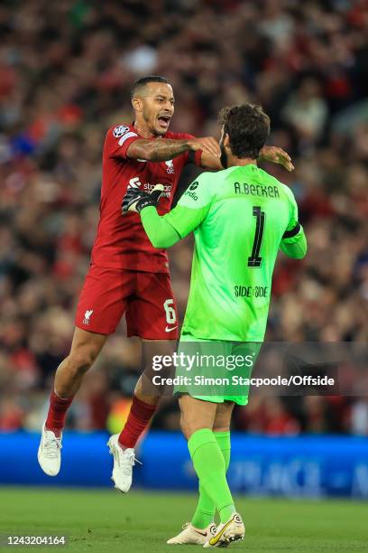 Thiago Alcantara of Liverpool celebrates their 1st goal with goalkeeper Alisson Becker during the UEFA Champions League group A match between...