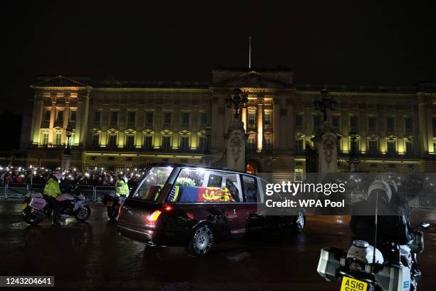 The Royal Hearse carrying the coffin of Queen Elizabeth II arrives at Buckingham Palace on September 13, 2022 in London, England. The coffin carrying...