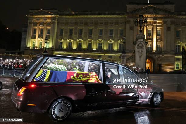 The Royal Hearse carrying the coffin of Queen Elizabeth II arrives at Buckingham Palace on September 13, 2022 in London, England. The coffin carrying...