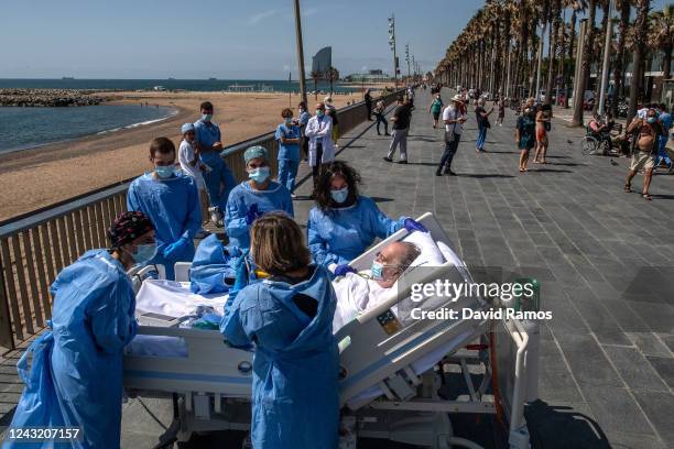 Hospital patient Isidre Correa is taken to the seaside by intensive health care staff outside the Hospital del Mar on June 03, 2020 in Barcelona,...