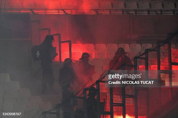 French CRS police move in the stands as flares are let off during the UEFA Champions League, Group D football match, between Olympique Marseille and...