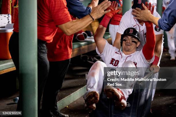 Reese McGuire of the Boston Red Sox is pushed in a laundry cart through the dugout after McGuire hit a home run during the third inning of a game...