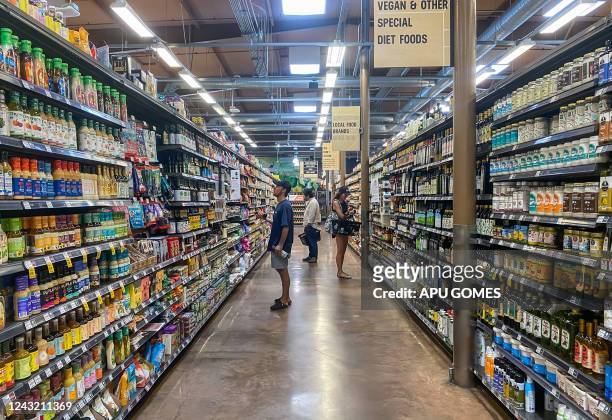 People shop at a supermarket in Santa Monica, California, on September 13, 2022. - US annual inflation slowed slightly in August, largely thanks to...