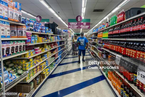 People shop at a 99 Cents store in Santa Monica, California, on September 13, 2022. - US annual inflation slowed slightly in August, largely thanks...