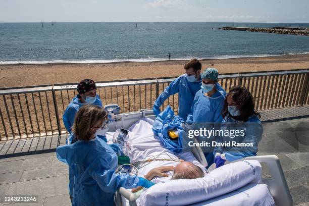 Hospital patient Isidre Correa is taken to the seaside by intensive health care staff outside the Hospital del Mar on June 03, 2020 in Barcelona,...