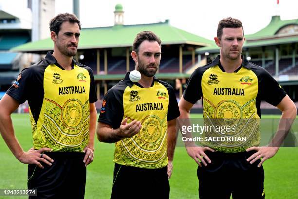 Australia's cricket players Mitchell Starc , Josh Hazlewood and Glenn Maxwell pose for pictures with new First Nations kit design for the upcoming...