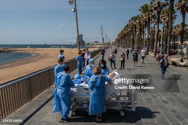 Hospital patient Isidre Correa is taken to the seaside by intensive health care staff outside the Hospital del Mar on June 03, 2020 in Barcelona,...