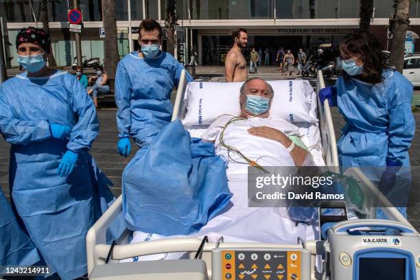 Hospital patient Isidre Correa is taken to the seaside by intensive health care staff outside the Hospital del Mar on June 03, 2020 in Barcelona,...