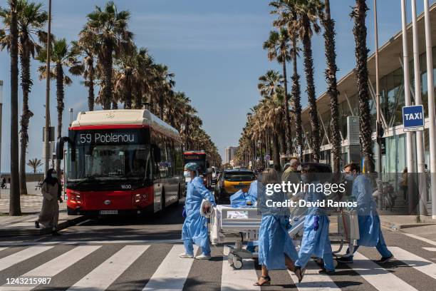 Hospital patient Isidre Correa is taken to the seaside by intensive health care staff outside the Hospital del Mar on June 03, 2020 in Barcelona,...