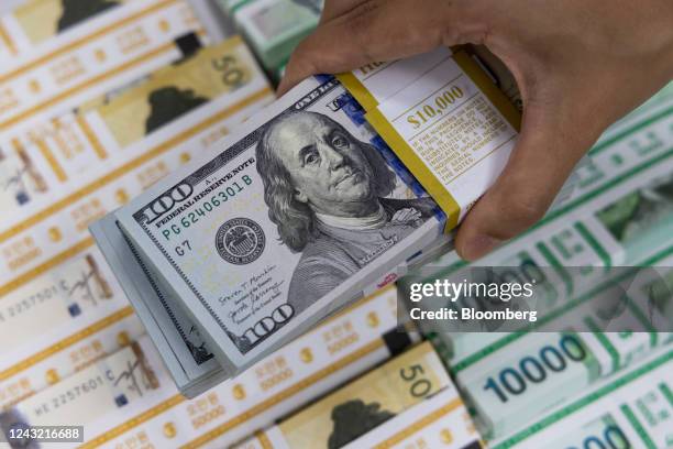 Bundles of U.S. 100 dollar banknotes arranged at the Shinhan Bank headquarters, a unit of Shinhan Financial Group Co., in Seoul, South Korea, Sept....