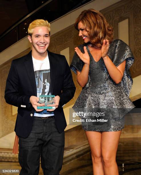 Designer Jimi Urquiago and model Kara Moncrief react after Urquiago won Las Vegas' Best New Designer contest at a Fashion's Night Out event at The...