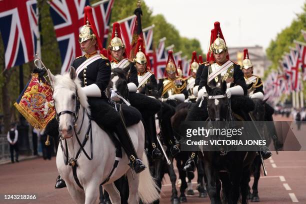 Members of the Household Cavalry get ready for a procession of the coffin of Britain's Queen Elizabeth II from Buckingham Palace to the Palace of...