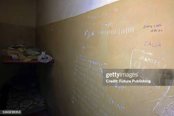 The words of the Lord's Prayer are written on the wall of a cell at the District Police Department used by Russian occupiers for torture, Balakliia,...