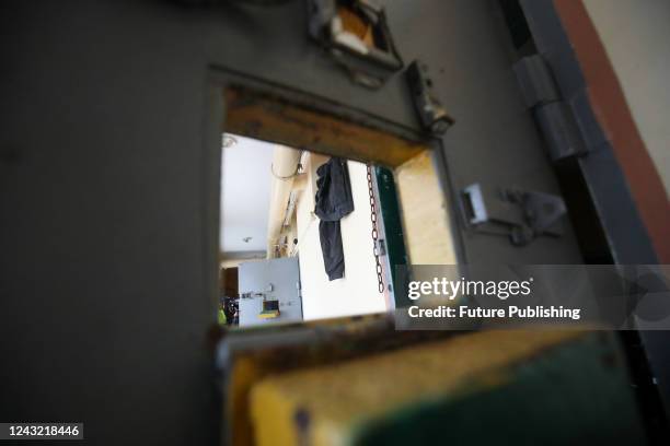 The window in the door frames the corridor at the District Police Department used by Russian occupiers for torture, Balakliia, Kharkiv Region,...