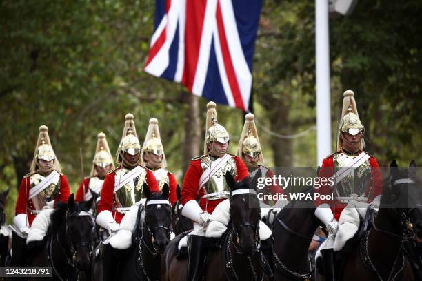 Soldiers of the Household Cavalry ride along The Mall on September 14, 2022 in London, United Kingdom. Queen Elizabeth II's coffin is taken in...