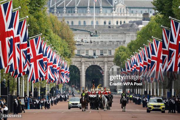 Members of the Household Cavalry make their way along the The Mall ahead of the coffin of late Queen Elizabeth II departing in procession to...