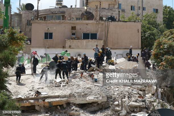 Jordanian rescue teams search for 10 people still missing under the rubble of a collapsed four-storey building in the capital Amman on September 14 a...