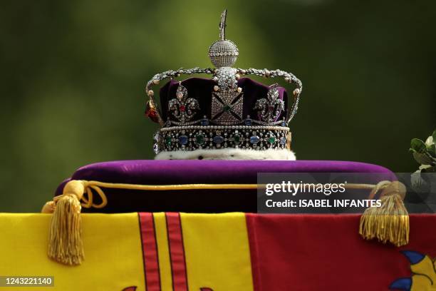 The coffin of Queen Elizabeth II, adorned with a Royal Standard and the Imperial State Crown is pulled by a Gun Carriage of The King's Troop Royal...