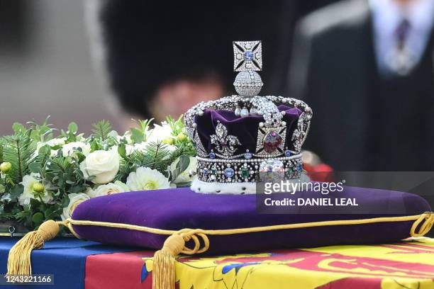 The coffin of Queen Elizabeth II, adorned with a Royal Standard and the Imperial State Crown is pulled by a Gun Carriage of The King's Troop Royal...