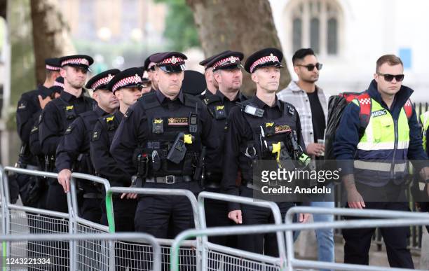 Police take security measures outside of the Buckingham Palace from where the coffin of Queen Elizabeth II to be departed in procession to...