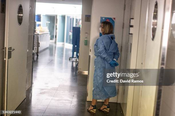 Isidre Correa's wife, Helena Soriano, waits outside the ICU before her husband, hospital patient Isidre Correa, is taken outside to the seaside by...