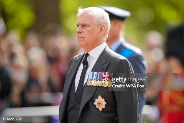 Prince Andrew, Duke of York walks behind the coffin during the ceremonial procession of the coffin of Queen Elizabeth II from Buckingham Palace to...