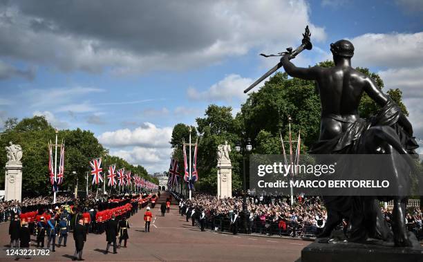 The coffin of Queen Elizabeth II, adorned with a Royal Standard and the Imperial State Crown is pulled by a Gun Carriage of The King's Troop Royal...