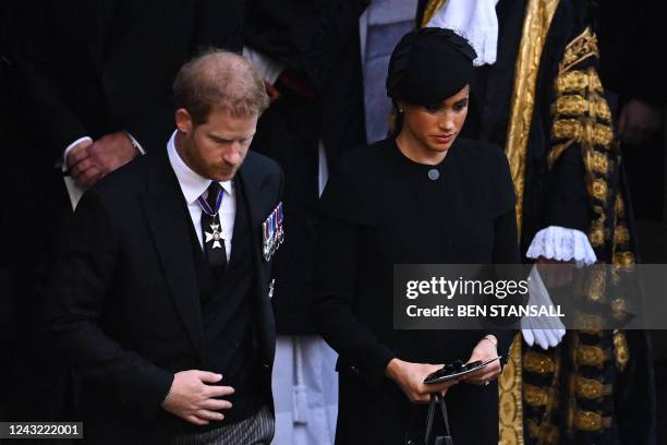 Britain's Prince Harry, Duke of Sussex and Meghan, Duchess of Sussex leave after a service for the reception of Queen Elizabeth II's coffin at...