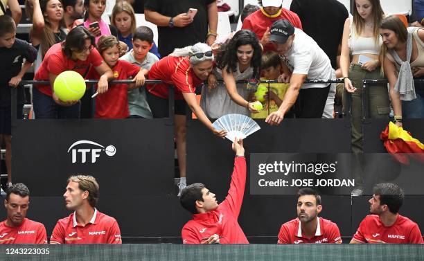 Spain's tennis player Carlos Alcaraz , next to Spain's tennis player Roberto Bautista Agut , Marcel Granollers and Pedro Martinez , meets supporters...