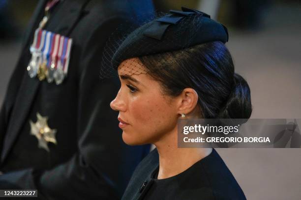 Meghan, Duchess of Sussex, stands after participating in the procession of the coffin of Queen Elizabeth II, to Westminster Hall, at the Palace of...