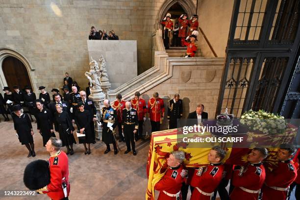 Pallbearers from The Queen's Company, 1st Battalion Grenadier Guards carry the coffin of Queen Elizabeth II past Britain's Camilla, Queen Consort,...