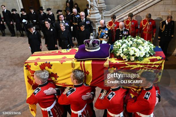Pallbearers from The Queen's Company, 1st Battalion Grenadier Guards carry the coffin of Queen Elizabeth II past Britain's Camilla, Queen Consort,...