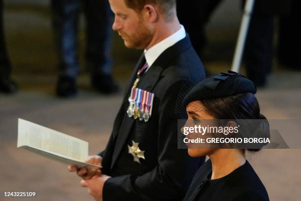 Britain's Prince Harry, Duke of Sussex and Meghan, Duchess of Sussex attend a service for the reception of Queen Elizabeth II's coffin at Westminster...