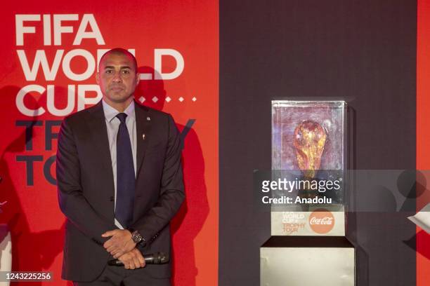 French former football player David Trezeguet poses for a photo with FIFA World Cup Trophy in Tunusia's capital Tunis as part of "FIFA World Cup...