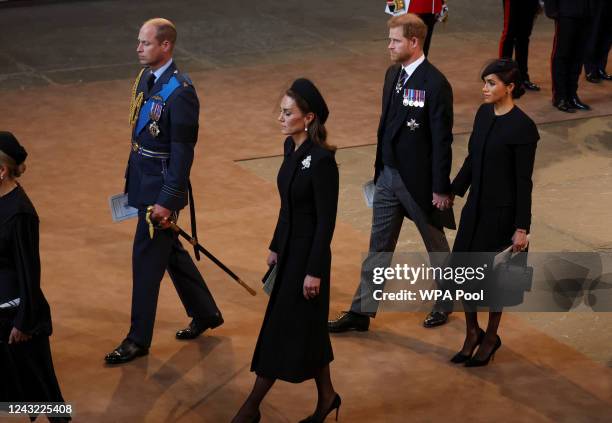 Prince William, Prince of Wales, Catherine, Princess of Wales, Prince Harry, Duke of Sussex and Meghan, Duchess of Sussex walk as procession with the...