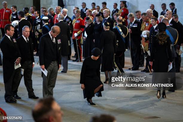 Britain's Prince Harry , Duke of Sussex, and Meghan , Duchess of Sussex, pay their respects inside Westminster Hall, at the Palace of Westminster,...