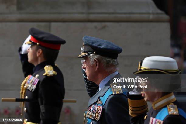 King Charles III and Princess Anne, Princess Royal salute as they pass the Cenotpah war memorial as they walk behind the coffin of Queen Elizabeth...