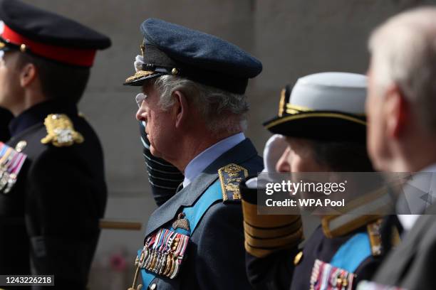 King Charles III and Princess Anne, Princess Royal salute as they pass the Cenotpah war memorial as they walk behind the coffin of Queen Elizabeth...