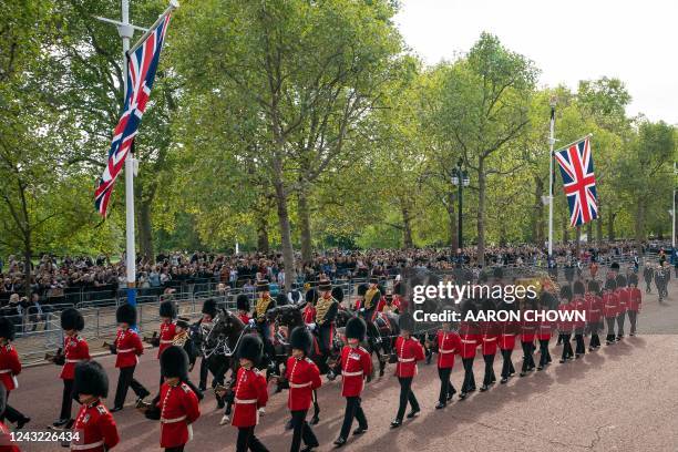 The coffin of Queen Elizabeth II, adorned with a Royal Standard and the Imperial State Crown is pulled by a Gun Carriage of The King's Troop Royal...