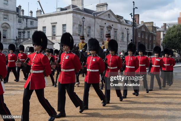 Members of the Grenadier Guards march alongside the coffin of Queen Elizabeth II, travelling in a ceremonial procession from Buckingham Palace to...