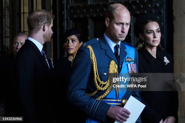 Prince William, Prince of Wales with Catherine, Princess of Wales and Prince Harry with Meghan, Duchess of Sussex leave after escorting the coffin of...