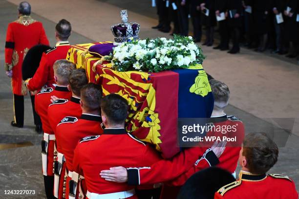 Pallbearers from The Queen's Company, 1st Battalion Grenadier Guards carry the coffin of Queen Elizabeth II into Westminster Hall on September 14,...