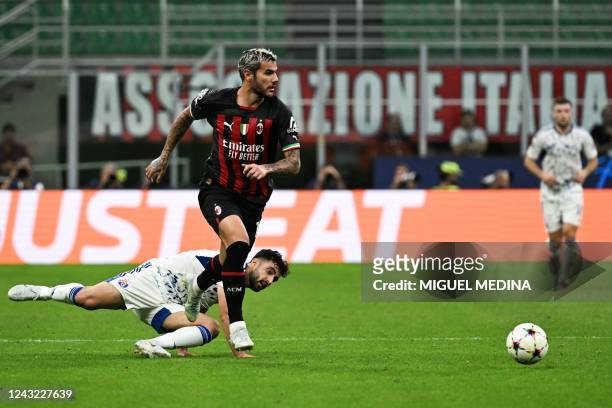 Dinamo Zagreb's Iranian defender Sadegh Moharrami fights for the ball with AC Milan's French defender Theo Hernandez during the UEFA Champions League...