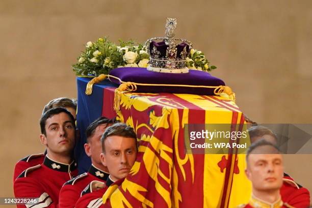 The Bearer Party from Queen's Company, 1st Battalion Grenadier Guards, carries the coffin of Queen Elizabeth II into Westminster Hall, London, where...